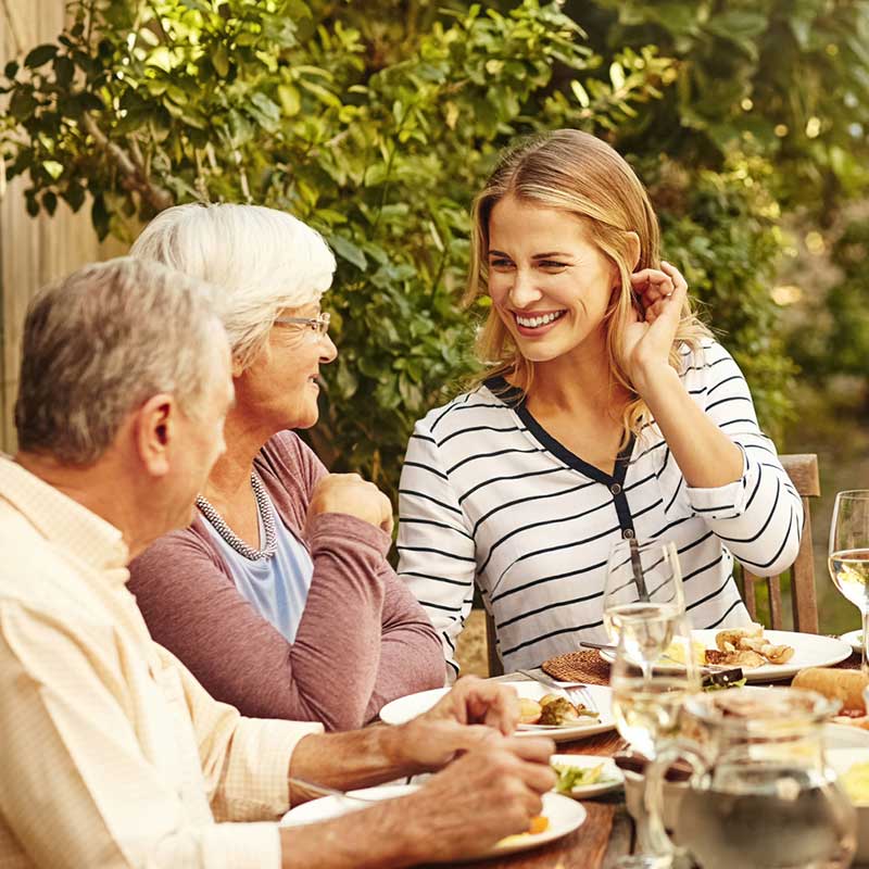 Family enjoying a fun conversation at dinner.